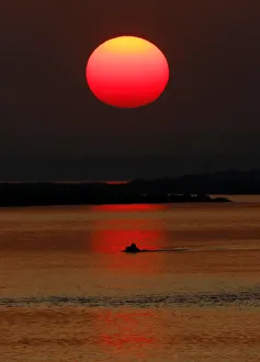 The sun sets over the place of a confluence of Angara and Yenisei rivers The sun sets over the place of a confluence of Angara and Yenisei rivers
