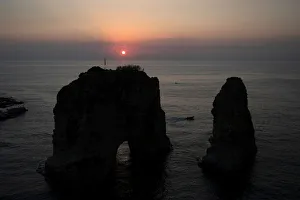 The sun sets behind the Raouche Rocks in Beirut The sun sets behind the Raouche Rocks in Beirut