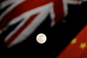 The super blue moon is seen between British and Chinese flags raised at Tiananmen square The super blue moon is seen between British and Chinese flags raised at Tiananmen square