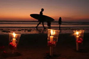 A surfer walks past candles during a commemoration of the 2002 Bali bombing in Kuta A surfer walks past candles during a commemoration of the 2002 Bali bombing in Kuta