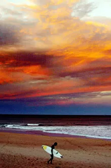 Images Dated 27th June 2002: SURFER WALKS ALONG SYDNEY BEACH AT SUNSET
