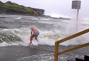 A swimmer is hit by wave as he enters the water in severe weather in Sydney A swimmer is hit by wave as he enters the water in severe weather in Sydney