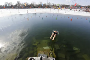 A swimmer jumps into Houhai Lake in central Beijing A swimmer jumps into Houhai Lake in central Beijing