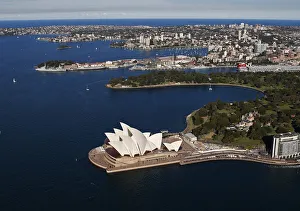 The Sydney Opera House is seen in front of some of the eastern suburbs on a sunny The Sydney Opera House is seen in front of some of the eastern suburbs on a sunny