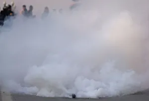 A tear gas shell fired by Indian police explodes during a protest march in Srinagar A tear gas shell fired by Indian police explodes during a protest march in Srinagar