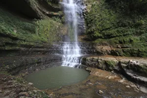 A tourist lies down near a waterfall at the Juan Curi natural park near the municipality A tourist lies down near a waterfall at the Juan Curi natural park near the municipality