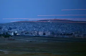 Tracer rounds cross the sky over the Syrian town of Kobani Tracer rounds cross the sky over the Syrian town of Kobani