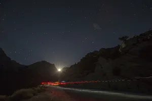A trail of headlamps is seen as runners make their way to the finish line in the Badwater A trail of headlamps is seen as runners make their way to the finish line in the Badwater