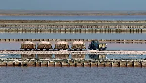 A train drives across the bed of a drained area of a lake used for the production of salt A train drives across the bed of a drained area of a lake used for the production of salt