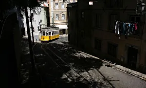 The tram 28 moves through an old neighborhood in Lisbon The tram 28 moves through an old neighborhood in Lisbon