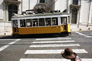 The tram 28 moves past an old building in Lisbon The tram 28 moves past an old building in Lisbon