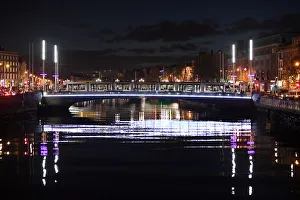 A tram crosses a bridge over the river Liffey at night in Dublin A tram crosses a bridge over the river Liffey at night in Dublin