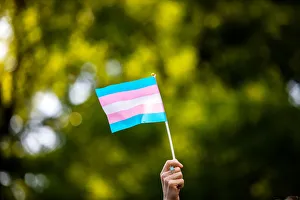 Transgender rights activist waves a transgender flag as they protest the killings of Transgender rights activist waves a transgender flag as they protest the killings of