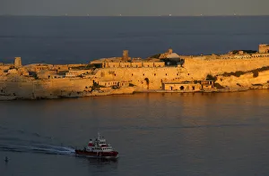 A tug boat passes the 17th century Fort Ricasoli as it enters Vallettas Grand Harbour A tug boat passes the 17th century Fort Ricasoli as it enters Vallettas Grand Harbour