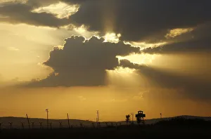 A Turkish border watch tower is silhouetted against the sunset at the Turkish-Syrian A Turkish border watch tower is silhouetted against the sunset at the Turkish-Syrian