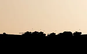 Turkish military are silhouetted on the top of a hill close to the border line between Turkish military are silhouetted on the top of a hill close to the border line between