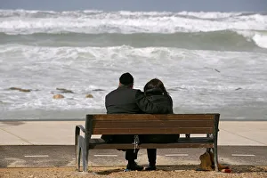 An ultra-Orthodox couple watches the sea during a storm in the Mediterranean coast of the An ultra-Orthodox couple watches the sea during a storm in the Mediterranean coast of the