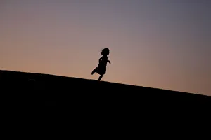 An Ultra-Orthodox girl enjoys herself as she vacations in the late summer season when An Ultra-Orthodox girl enjoys herself as she vacations in the late summer season when
