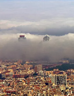 Images Dated 26th May 2005: An unusual fog settles over Barcelonas city coastline