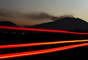 A vehicle passes along a highway as smoke is emitted from the Galeras volcano in Chachagui A vehicle passes along a highway as smoke is emitted from the Galeras volcano in Chachagui