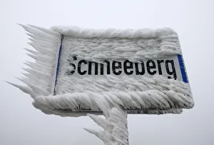 A village sign is covered with ice in Schneeberg A village sign is covered with ice in Schneeberg