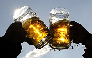 Visitors toast each other on a sunny day during Oktoberfest in Munich Visitors toast each other on a sunny day during Oktoberfest in Munich