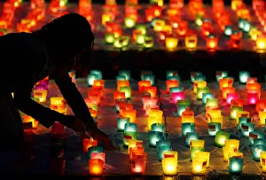 A volunteer sets up candles during Swiss national day in Berne A volunteer sets up candles during Swiss national day in Berne