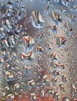 Water droplets on a window reflect Housing Development Board apartment flats in Singapore Water droplets on a window reflect Housing Development Board apartment flats in Singapore