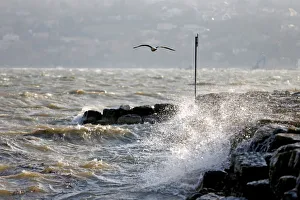 Waves crash on the lakeside of the Lake of Geneva on a windy day in Geneva Waves crash on the lakeside of the Lake of Geneva on a windy day in Geneva
