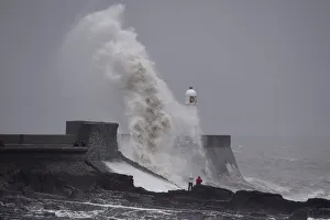Waves crash over the lighthouse at Porthcawl, Wales Waves crash over the lighthouse at Porthcawl, Wales
