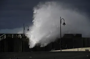 Waves crash against a seafront a the port town of Puerto de Vega Waves crash against a seafront a the port town of Puerto de Vega