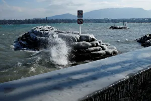 Waves splash on the shore during a windy winter day near Lake Leman in Geneva Waves splash on the shore during a windy winter day near Lake Leman in Geneva