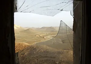 A window with broken glass overlooks the Lebanese-Syrian border as seen from a Lebanese A window with broken glass overlooks the Lebanese-Syrian border as seen from a Lebanese