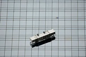 A window washing scaffolding unit hangs precariously from a skyscraper at Columbus Circle A window washing scaffolding unit hangs precariously from a skyscraper at Columbus Circle