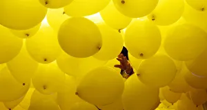 A woman arranges balloons to be released into the skies above Sao Paulo downtown during A woman arranges balloons to be released into the skies above Sao Paulo downtown during