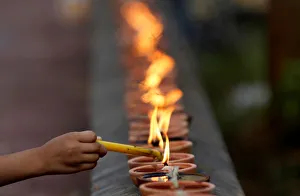 A woman burns a candle at a pagoda during Vesak Bochea Day on the outskirts of Phnom Penh A woman burns a candle at a pagoda during Vesak Bochea Day on the outskirts of Phnom Penh