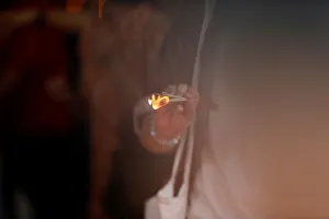 A woman burns incense sticks during the Lunar New Year celebrations at Wat Mangkon A woman burns incense sticks during the Lunar New Year celebrations at Wat Mangkon
