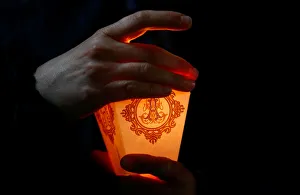 Woman holds a candle during the annual Icon of the Mother of God procession in the Woman holds a candle during the annual Icon of the Mother of God procession in the
