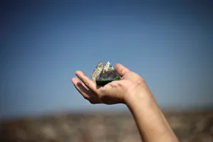 A woman holds a pyramid figure towards the sun to welcome the spring equinox in the A woman holds a pyramid figure towards the sun to welcome the spring equinox in the