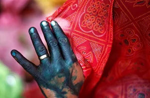 A woman holds her veil as she takes part in Huranga, a game played between men A woman holds her veil as she takes part in Huranga, a game played between men