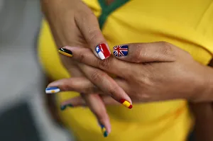 A woman shows her nails after being painted with the flags of countries that will A woman shows her nails after being painted with the flags of countries that will
