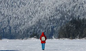 Woman takes a walk over the frozen up lake Eibsee in Grainau near Garmisch-Partenkirchen Woman takes a walk over the frozen up lake Eibsee in Grainau near Garmisch-Partenkirchen