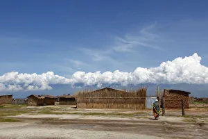 A woman walks among houses in Gatumba, outside Bujumbura A woman walks among houses in Gatumba, outside Bujumbura