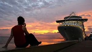 A woman watches the sunset at the Summit of the Americas in Trinidad A woman watches the sunset at the Summit of the Americas in Trinidad