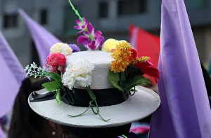 A woman wears a hat with flowers during a demonstration as part of International Women's A woman wears a hat with flowers during a demonstration as part of International Women's