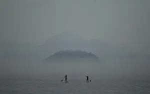 Two women paddle on stand up paddle boards at Copacabana beach in Rio de Janeiro Two women paddle on stand up paddle boards at Copacabana beach in Rio de Janeiro