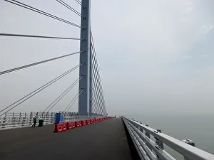 A worker walks on the Hong Kong-Zhuhai-Macau bridge under construction in Zhuhai A worker walks on the Hong Kong-Zhuhai-Macau bridge under construction in Zhuhai