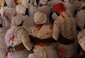 Worshippers with stains of goats blood on their clothes participate in a ceremony during Worshippers with stains of goats blood on their clothes participate in a ceremony during