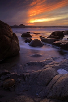 Cornish Coastline Views Prints: View of eroded rock formations on beach at sunset, near Lands End, Cornwall, England