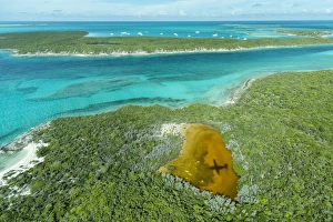 Aerial photo looking down at the airplanes shadow and clear tropical water Aerial photo looking down at the airplanes shadow and clear tropical water